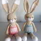 large crocheted bunnies in pink and blue clothes - baby soft toy