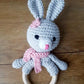 pink and grey bunny ring rattle with embroidered eyes for baby's safety