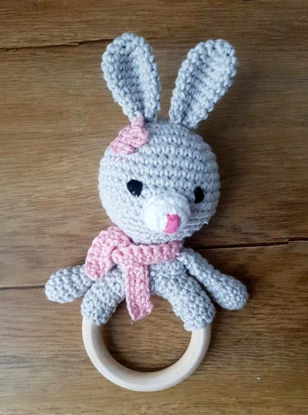 pink and grey bunny ring rattle with embroidered eyes for baby's safety