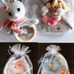 deluxe gift sets showing bunny with owl and fish sets packaged in gauze bags