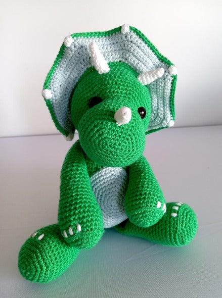 crocheted green triceratops toy with safety eyes