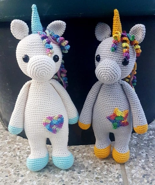 Upright unicorn: off-white with teal plus heart and grey with mustard plus star